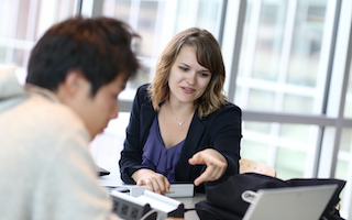Advising with woman pointing to screen with student viewing computer