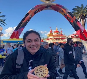 Paul Marino Edwards smiling and holding a pastry