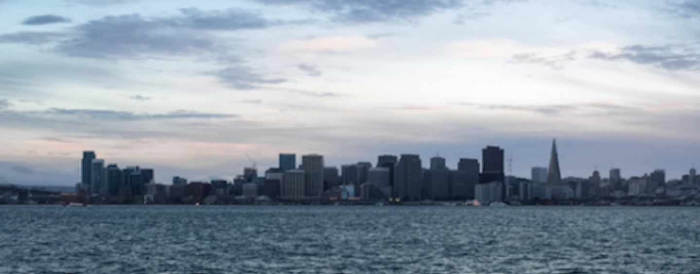 Sea and cityscape during a cloudy day